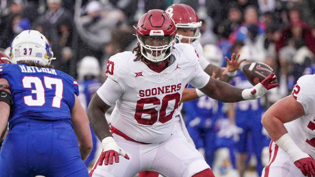 Oklahoma Sooners offensive lineman Tyler Guyton (60) at the line of scrimmage against the Kansas Jayhawks during the game at David Booth Kansas Memorial Stadium.
